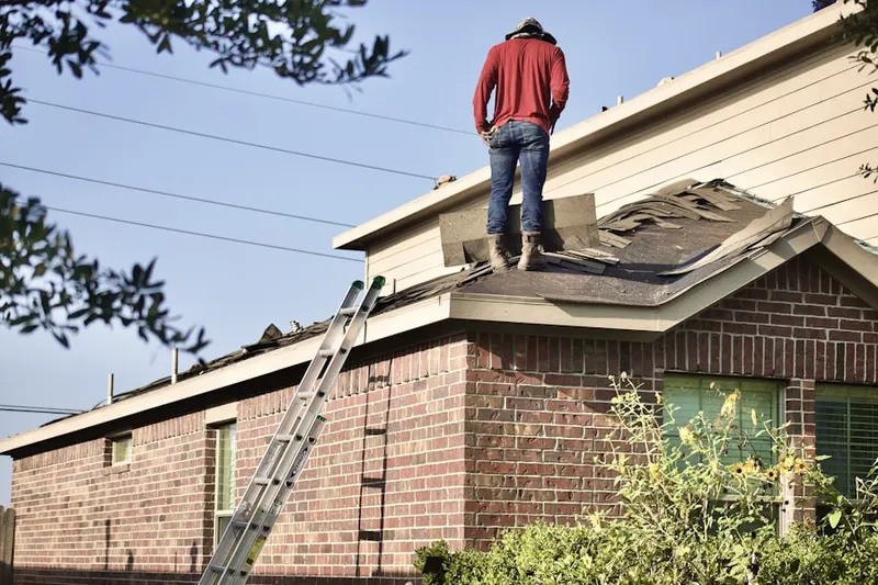 Professional roofer working on a residential roof in Northrup